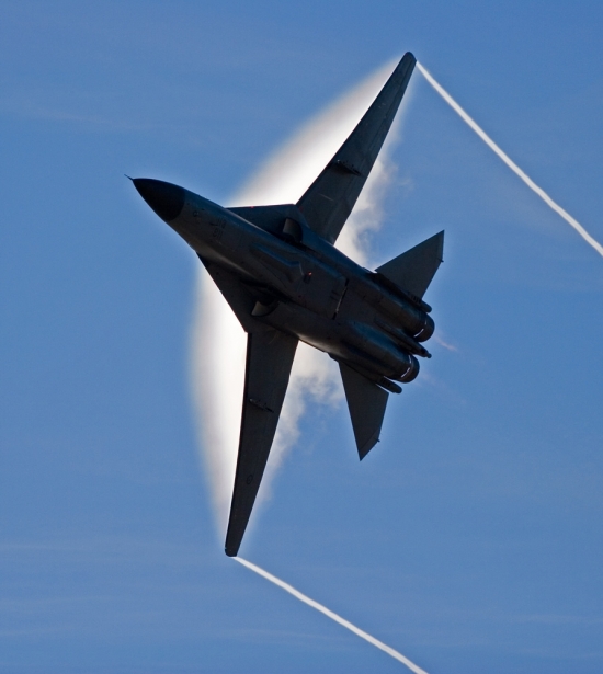 F-111 pulling Gs with vapor cloud forming over the wings