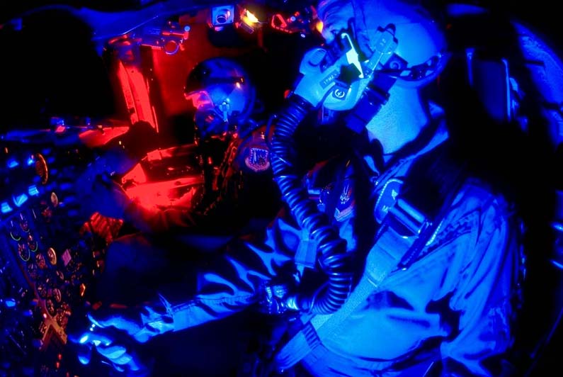 F-111 pilot and Wizzo at night in the side-by-side cockpit